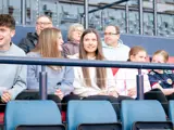 A group of people sit on the west subs bench at Hampden Park and admire the view the players get on matchdays